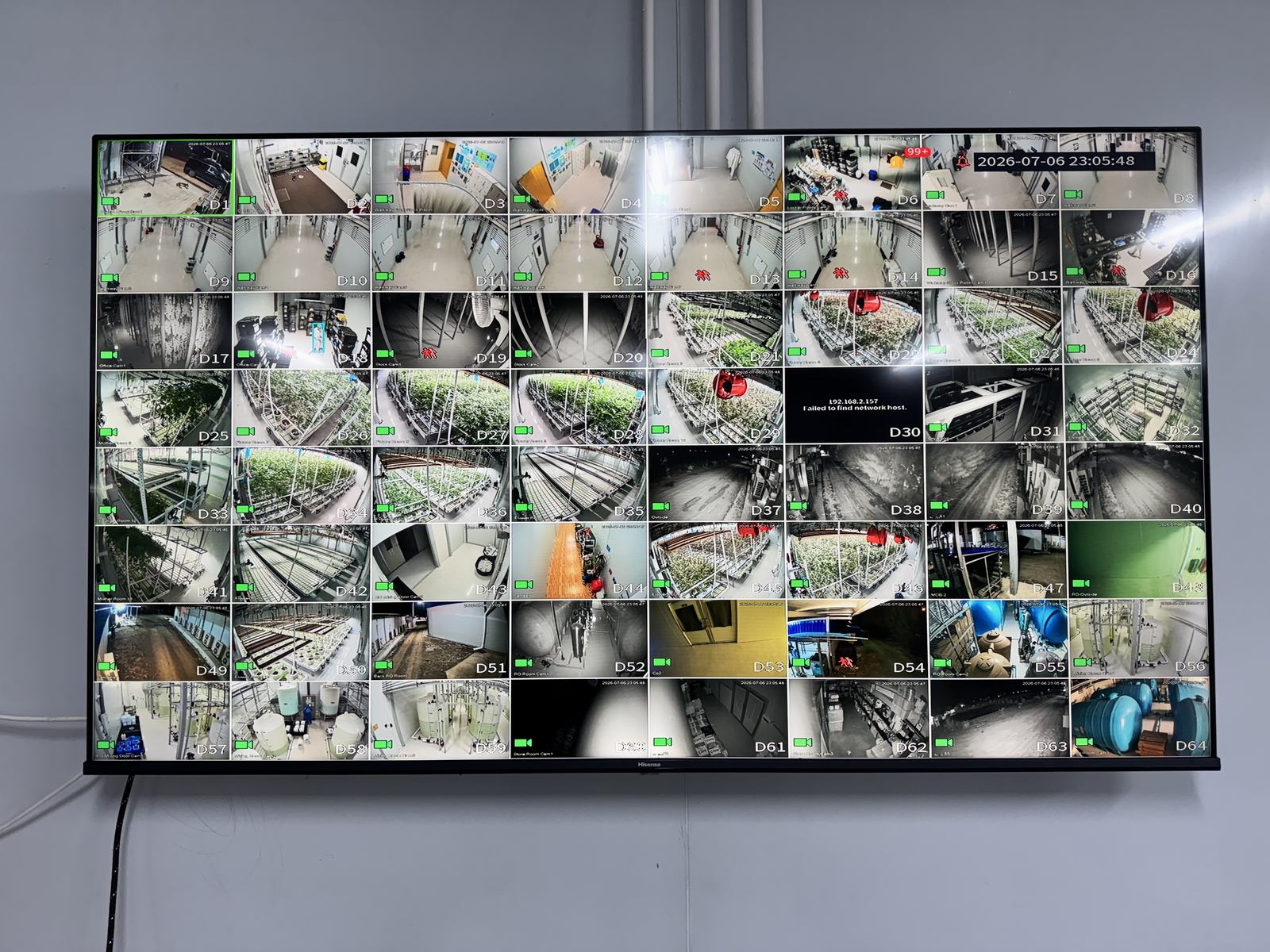 Facility CCTV monitoring wall — camera coverage across production rooms