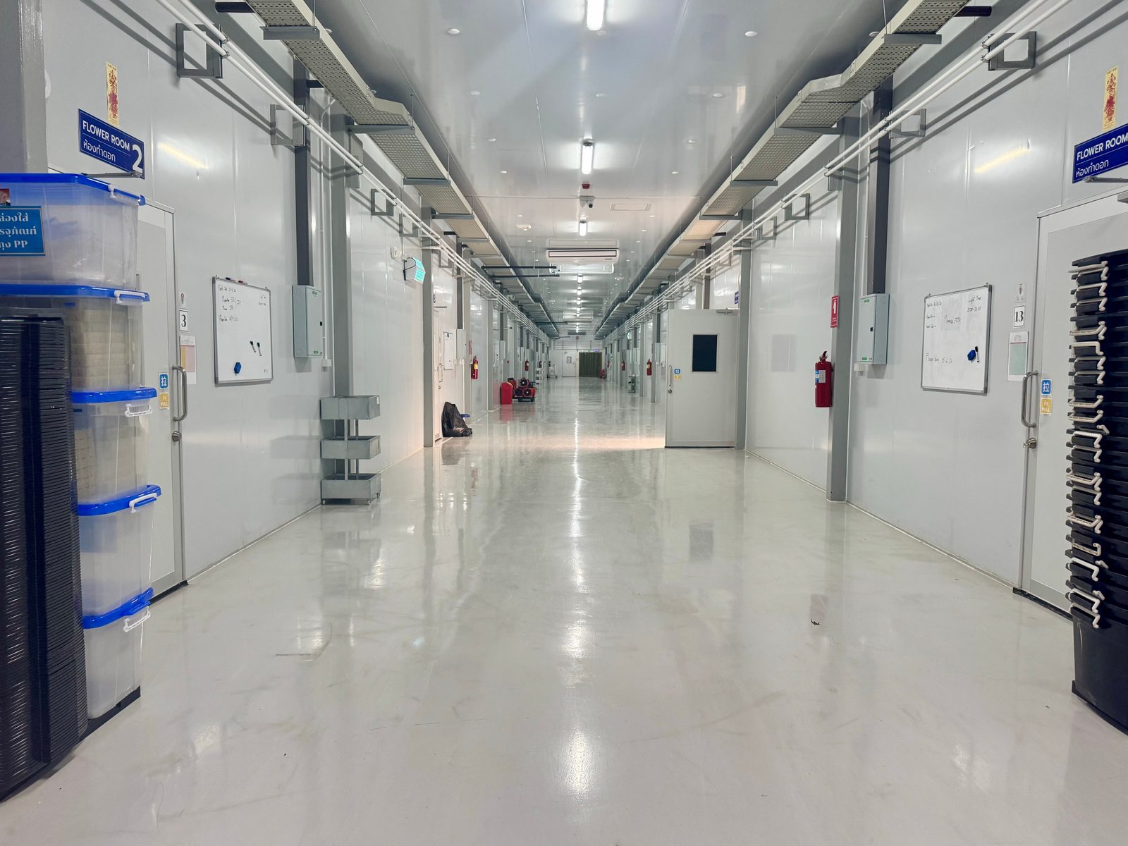 Controlled-environment facility corridor with numbered flower rooms